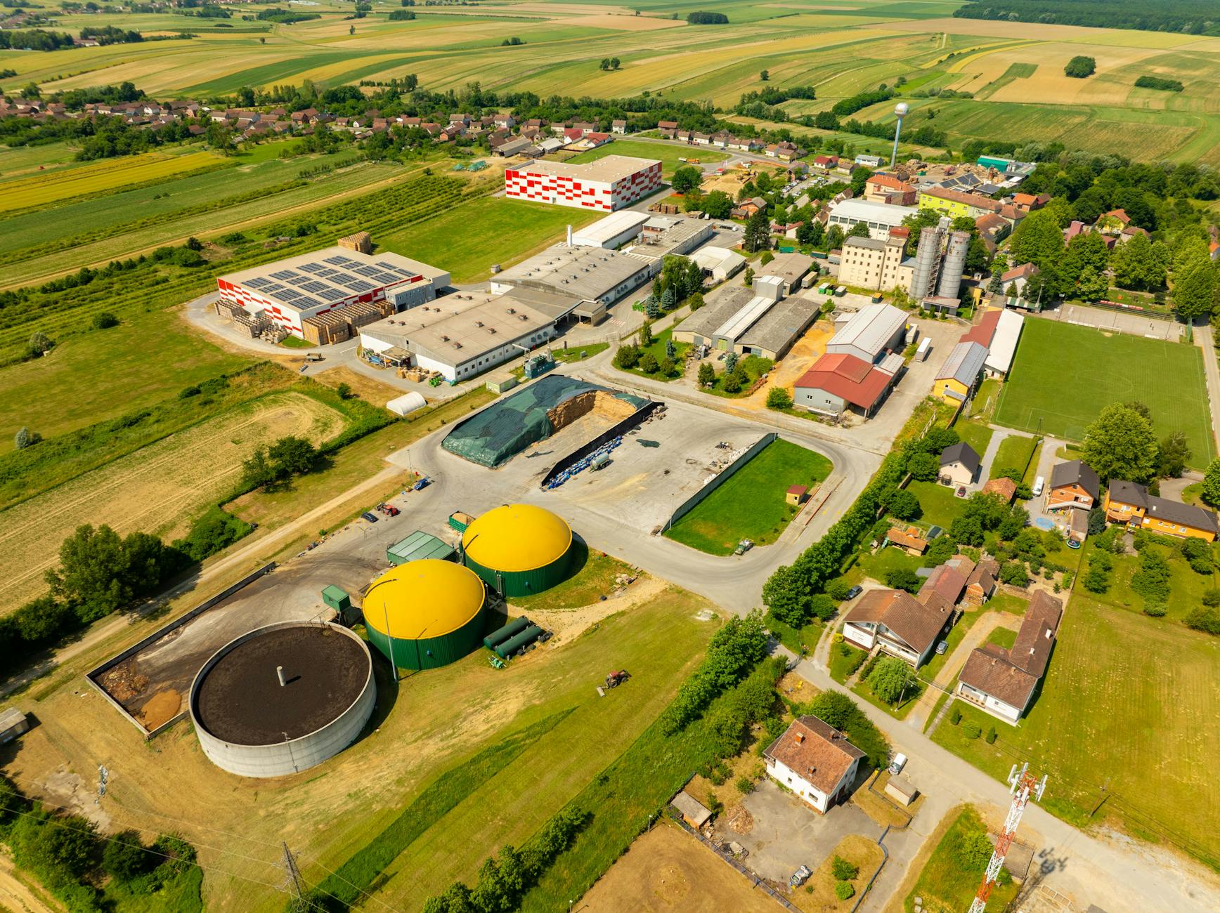 Widok z lotu ptaka na zakład przemysłowy wśród terenów zielonych